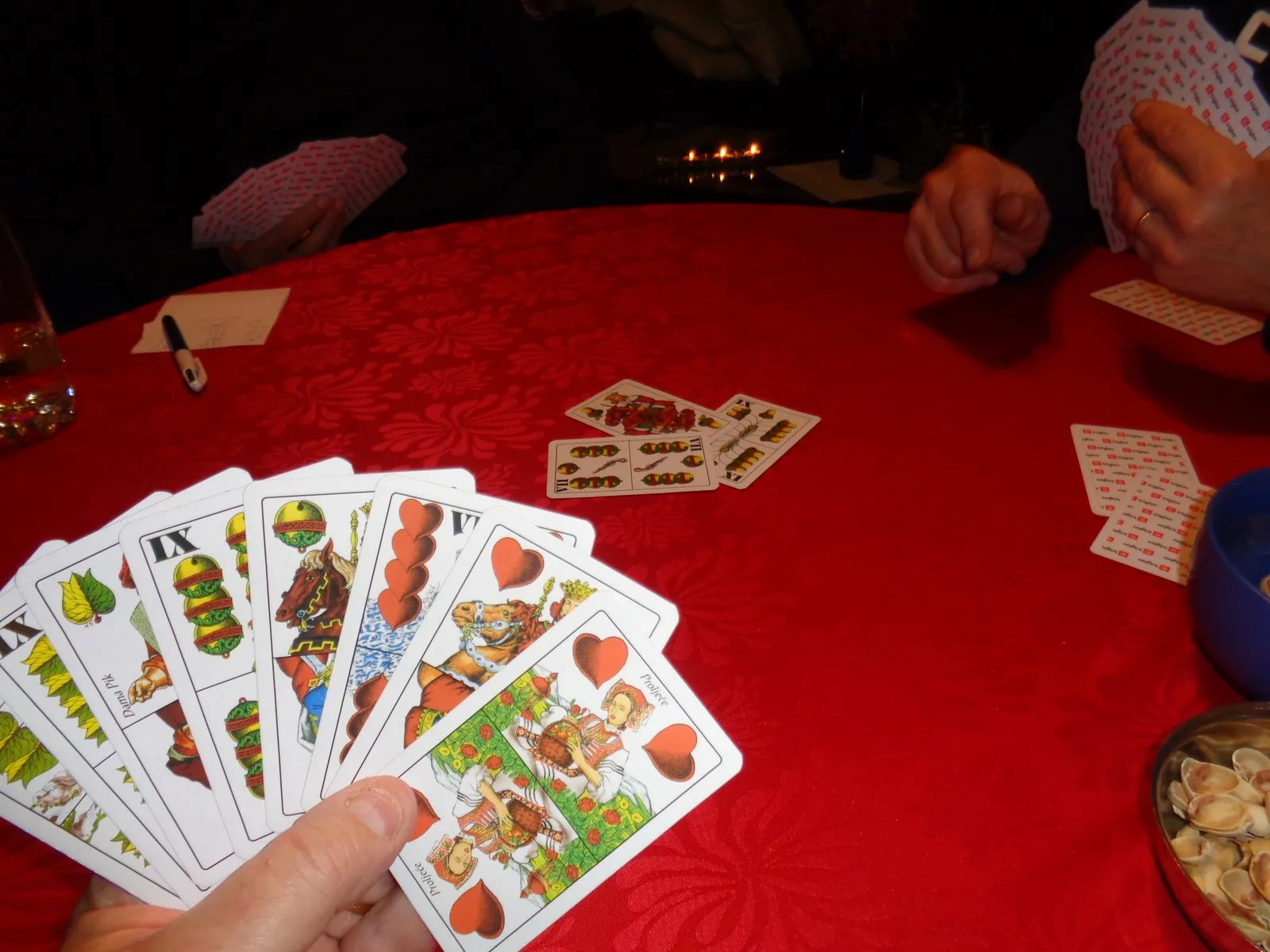 Traditional Central European cards in a player’s hand at a table